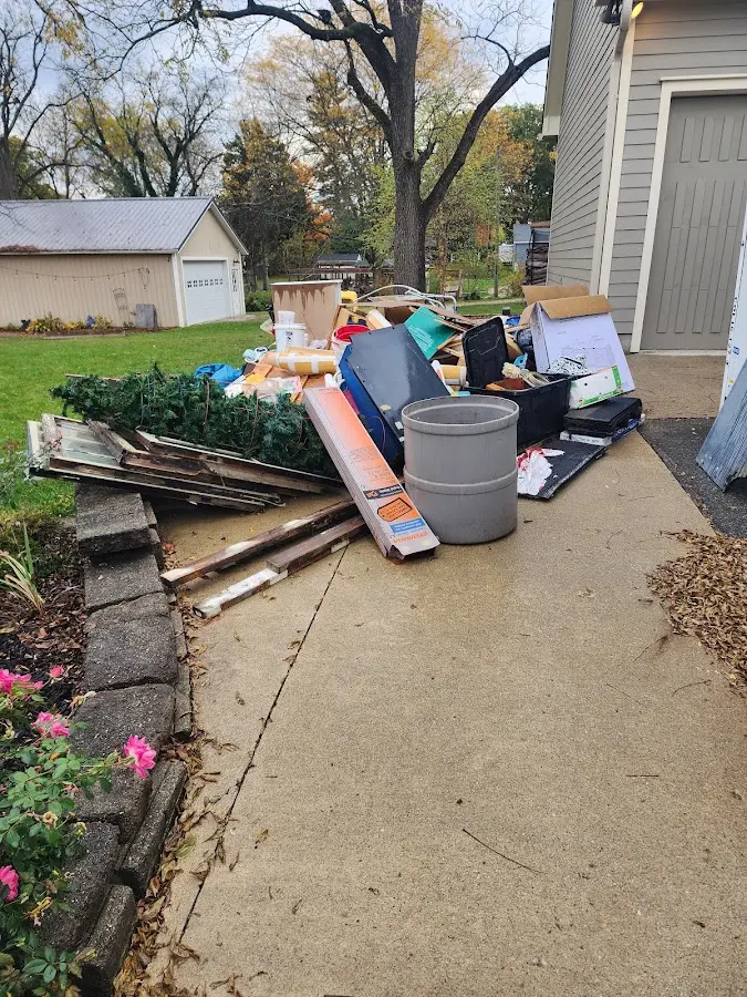 Dumpster being loaded with debris for 12 Yard Dumpster Rental in Spring Garden